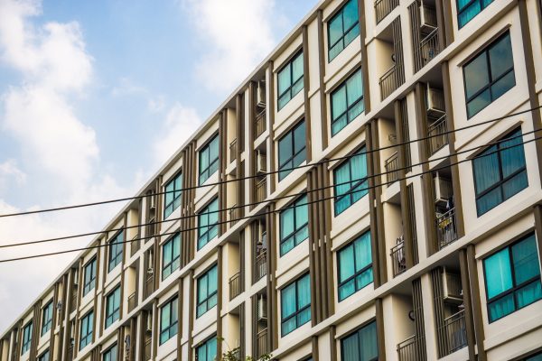Modern condominium block building with blue sky cloud real estate business industry