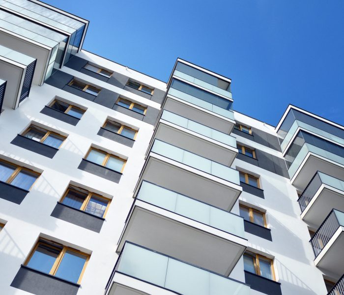 Multistory new modern apartment building. Stylish living block of flats.