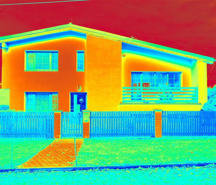 Low emission fasade and heat losses measurement result. Building after complete insulation. Infrared thermovision display. Photo building color scale, heat dispersion.